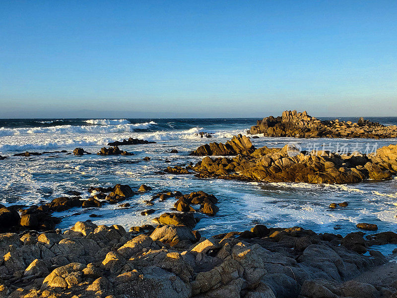 加利福尼亚多岩石的海滩上傍晚的巨浪。