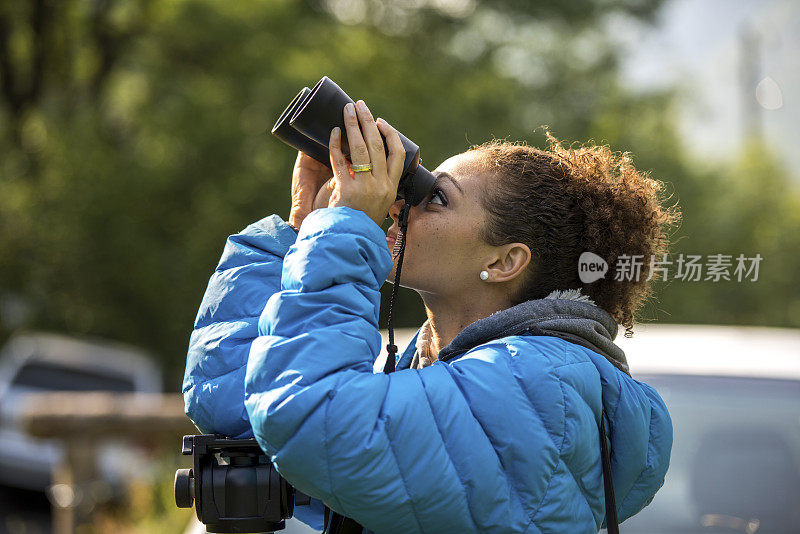 在瑞士伯尔尼坎顿，一名妇女透过双筒望远镜看东西。