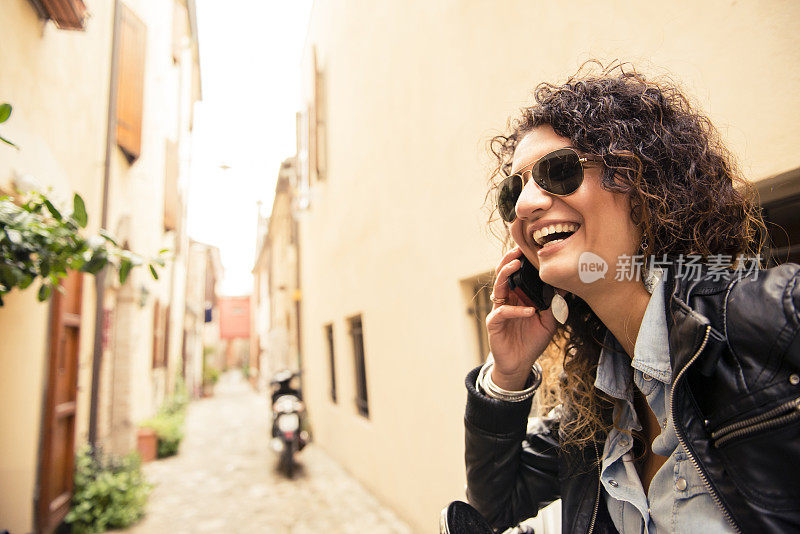 一个年轻的意大利女人在用她的智能手机