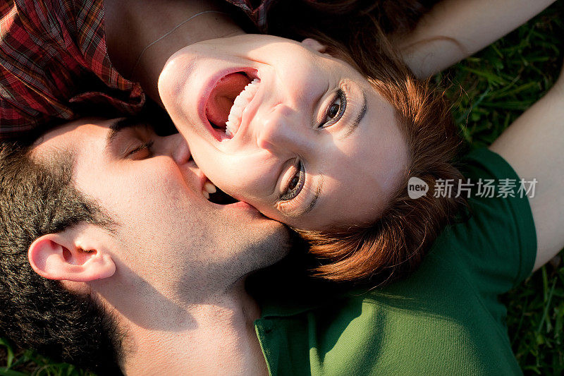 情侣接吻，躺在草地上