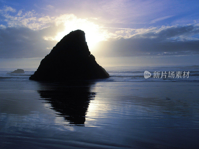 日落在海滩后面的岩石露头