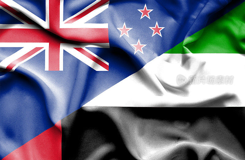 挥舞着阿拉伯联合酋长国和新西兰的旗帜