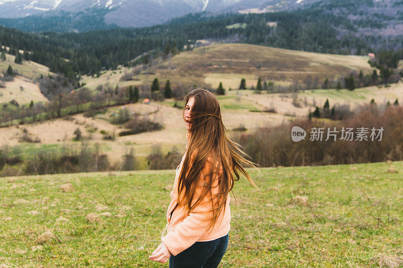 年轻的女旅行者在山里是快乐的!