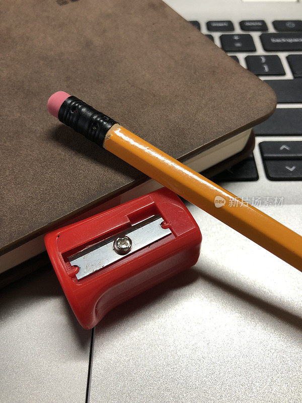 铅笔，卷笔刀和笔记本电脑上的记事本