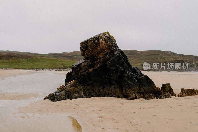 阴沉的日子里，海滩上突出的岩石尖顶