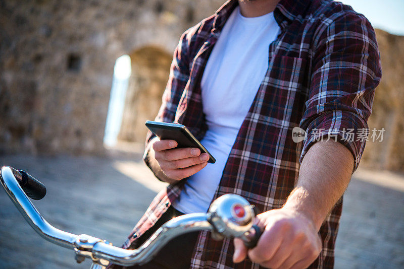 骑自行车的男人在看手机