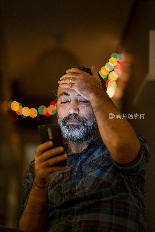 一个成年人正在家里看他的手机