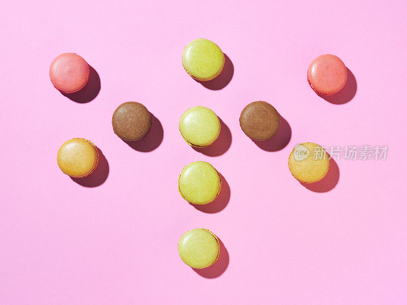 高角度视图排列蛋白杏仁饼干在粉红色的背景