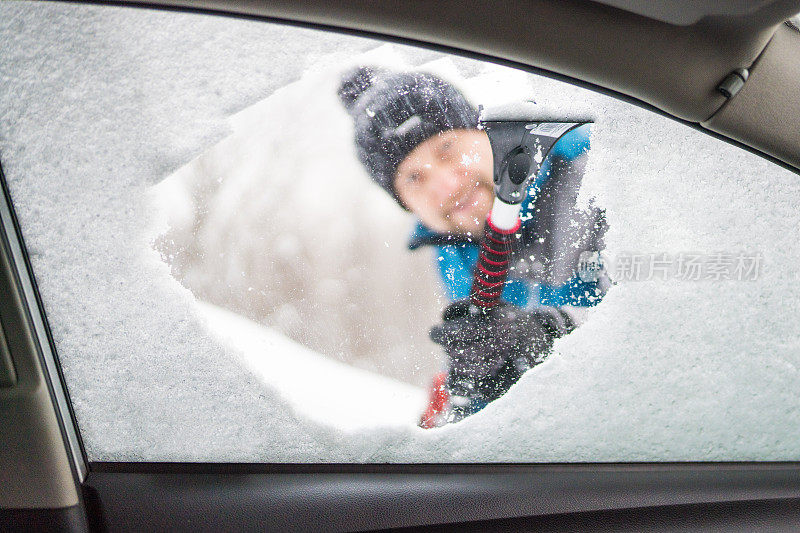 刮着车窗外的冰雪，男人正看着车窗外