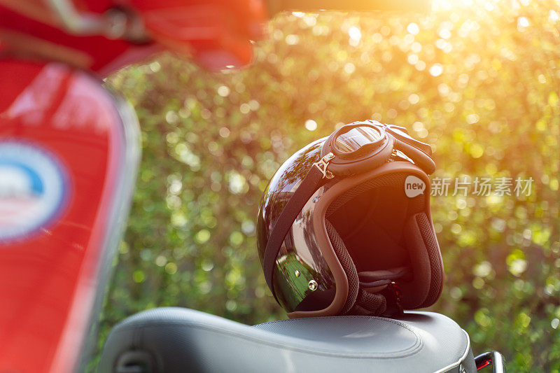摩托车后座上的复古头盔。准备好旅行，安全旅行的理念。