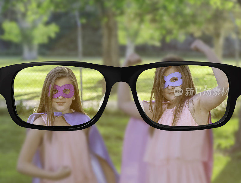 视野清晰的双胞胎姐妹在公园里扮演超级英雄