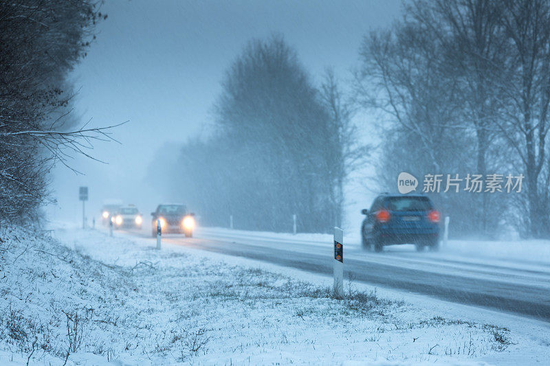 大雪时汽车行驶在被雪覆盖的街道上