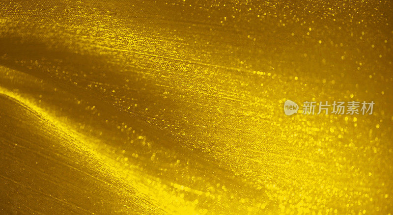 金色闪光圣诞抽象背景丝波尘埃粒子黄色图案假日纹理微细摄影