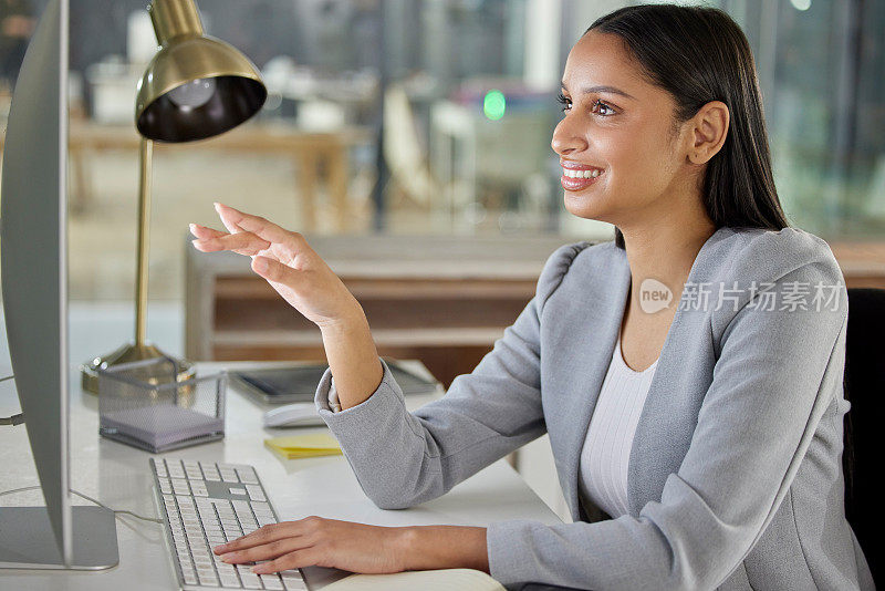 一位年轻的女商人在现代办公室里使用电脑