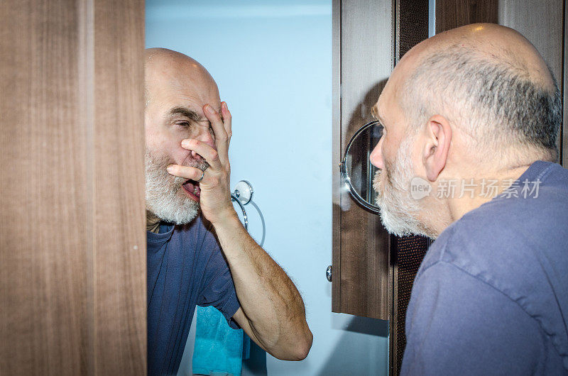 男人站在镜子前，心情复杂