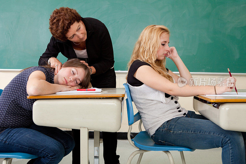 老师检查睡着的学生的脉搏