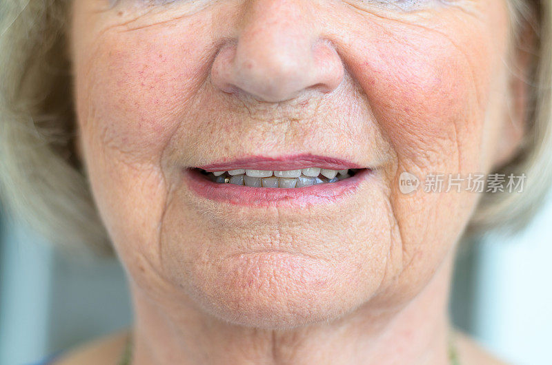 一位年长女性的下半张脸，嘴唇半掩着