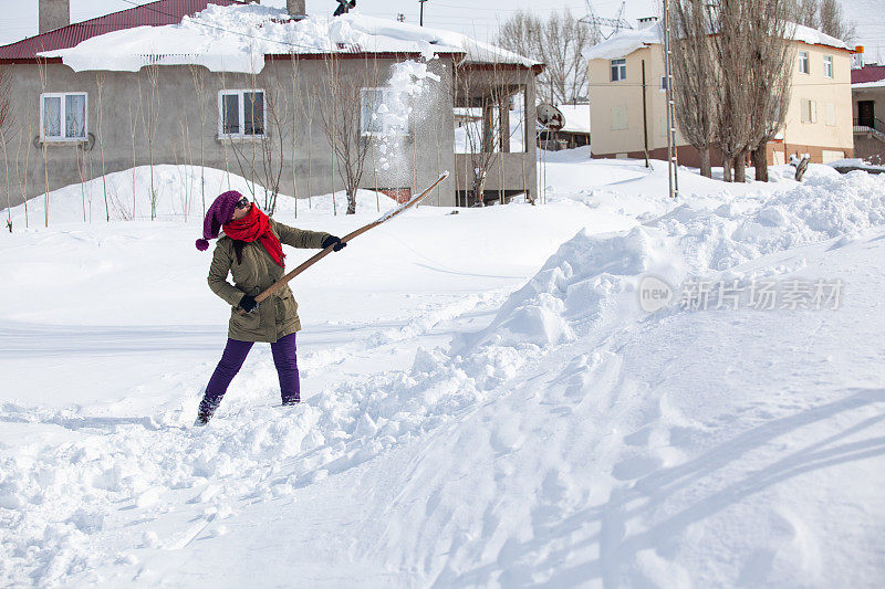 村里的成年妇女在清扫积雪