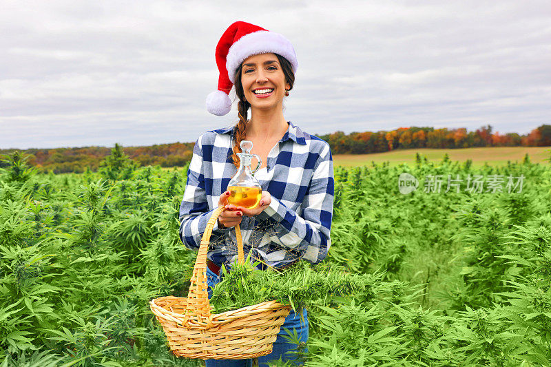 年轻女子拿着CBD油和新切的大麻作为礼物