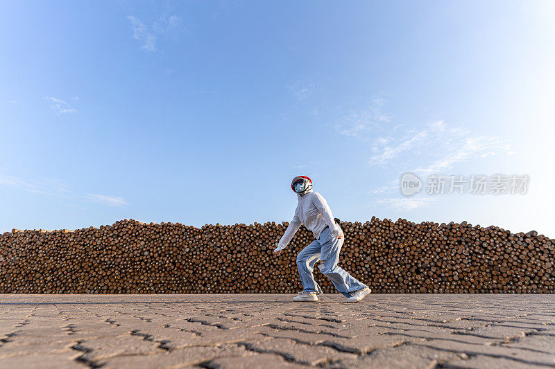 一名蒙面女子在木材堆垛区跳了起来