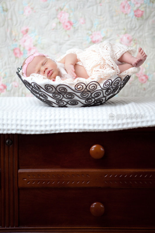 熟睡的新生儿与头巾在篮子里