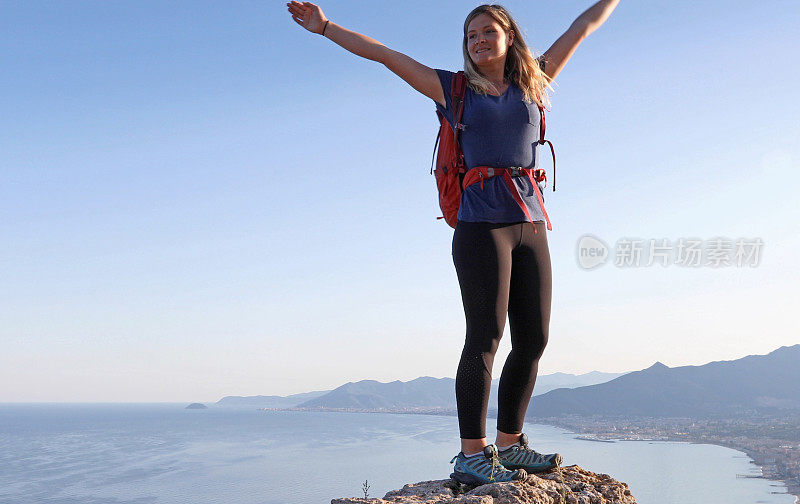 女徒步旅行者站在岩石山顶