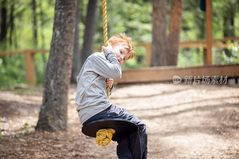 可爱的红发男孩在公园玩得很开心