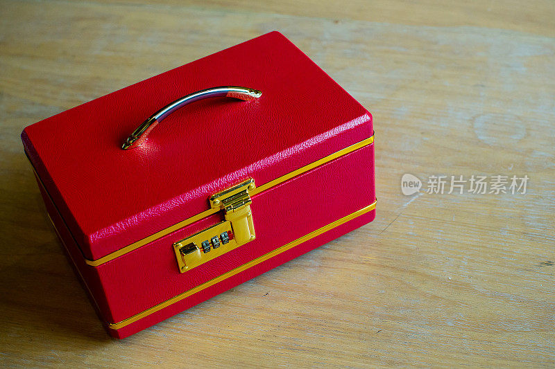 豪华的红色提手盒子在木桌上。珠宝盒。红色的盒子。