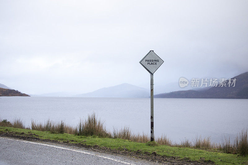 在苏格兰一个湖旁的一条单行道上指示一个经过的地方的路标