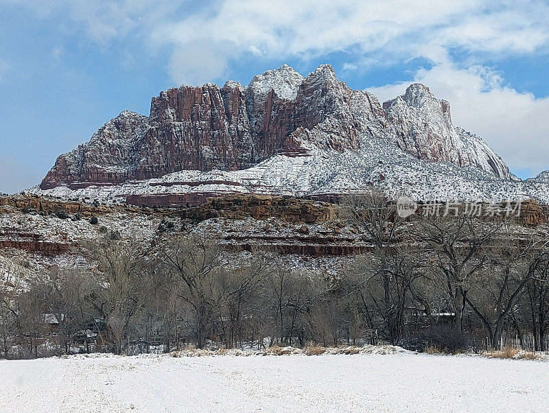 在犹他州洛克维尔的格拉夫顿路上，冬天被雪覆盖的牧场，背景是锡安国家公园