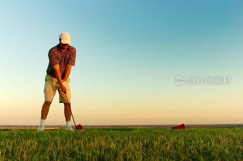 日落时分，一个人在打高尔夫球