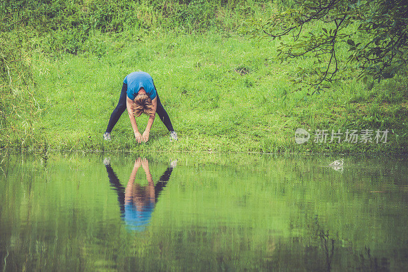 地中海运动老年人伸展-妇女在雨林中锻炼