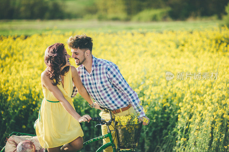 爱的夫妇有乐趣的户外驾驶自行车在夏天的时间