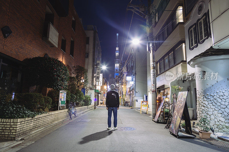 一名游客站在浅草的夜间街道上