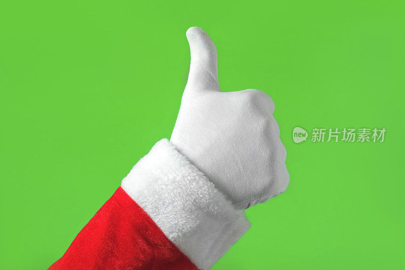 圣诞老人拇指朝下的手势被隔离在绿色背景上。关闭了。不是,不喜欢。色度键屏幕。肢体语言。戴着白手套的手做负号。坏的行为。