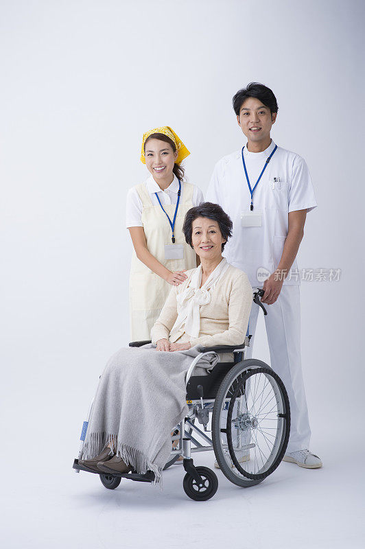 轮椅上的老年妇女、医生和护理人员