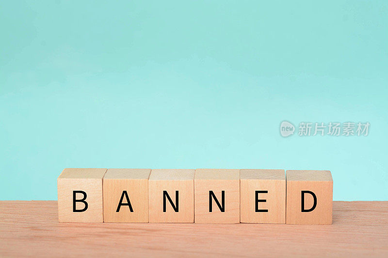 带有文字的木块。ban指的是对某一特定活动、行动、物品或人的正式或官方禁止或限制。这是政府作出的权威决定