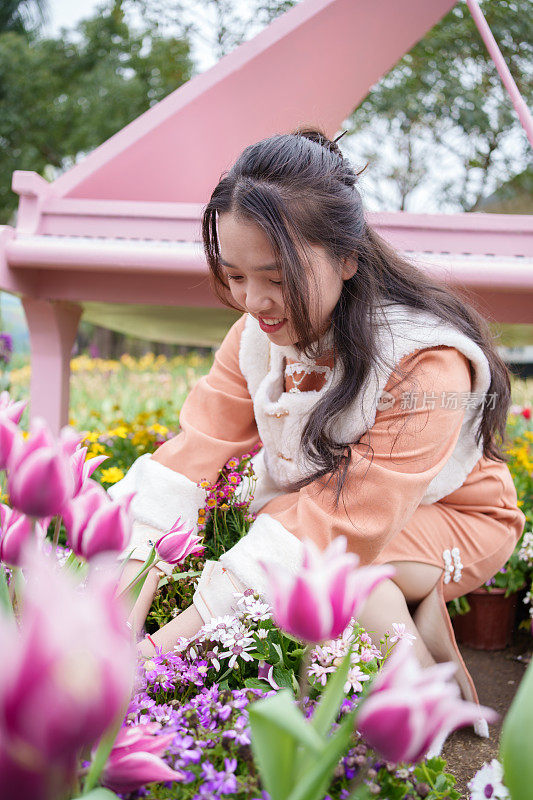 欣赏金色花朵的亚洲妇女