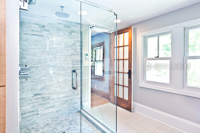 当代家庭浴室玻璃淋浴摊位与大理石瓷砖