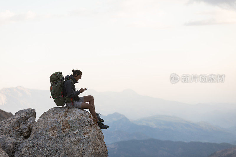 登山者在山顶使用智能手机