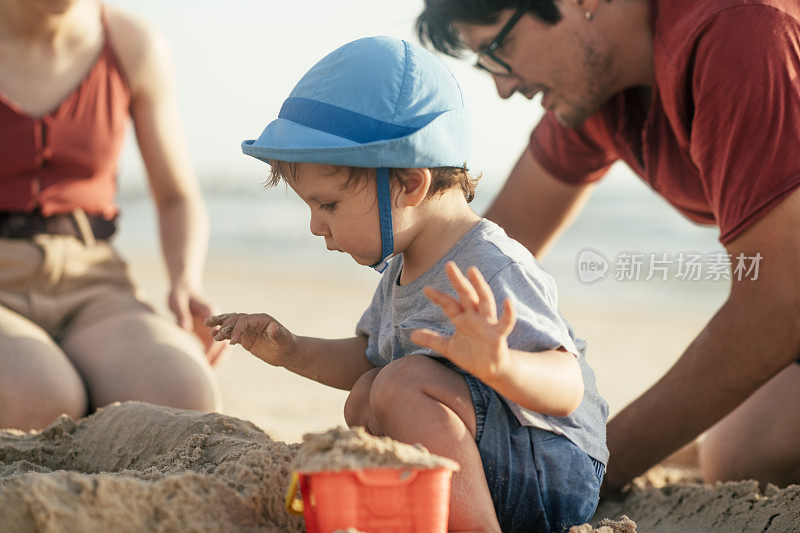 一家人在海边的沙滩上建了一个沙堡