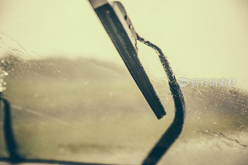 在一个非常下雨的日子里，在新布伦瑞克的道路上驾驶的一个挡风玻璃刮水器的特写。