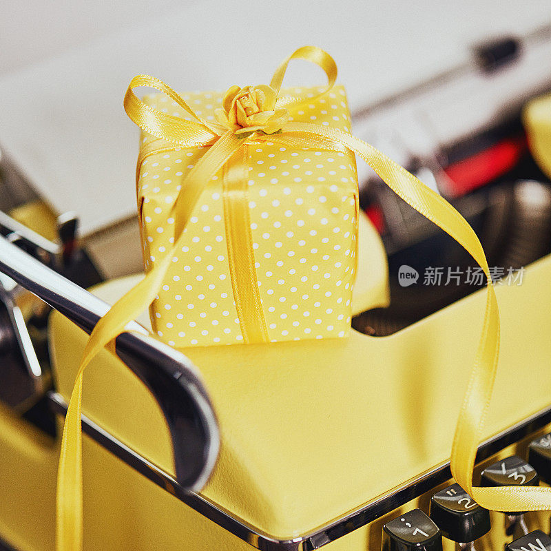 彩色老式黄色打字机与黄色礼物
