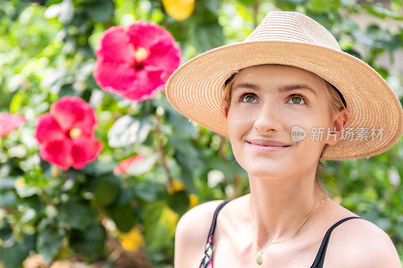 女人在花园和热带芙蓉