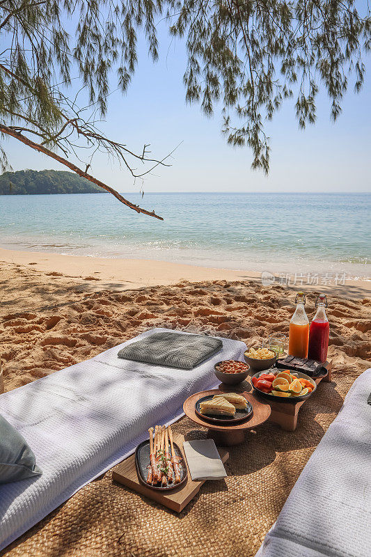 海滩野餐在海边小吃，水果和果汁饮料