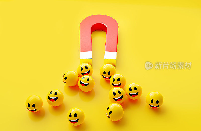 带有笑脸表情的黄色球体被黄色背景上的红色磁铁吸引