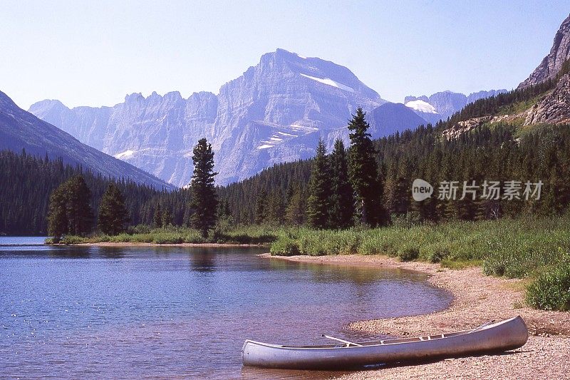 在蒙大拿州冰川国家公园激流湖沿岸的沙洲上的独木舟