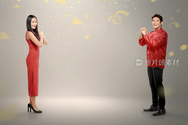 侧面的中国夫妇穿着传统服装和纸屑