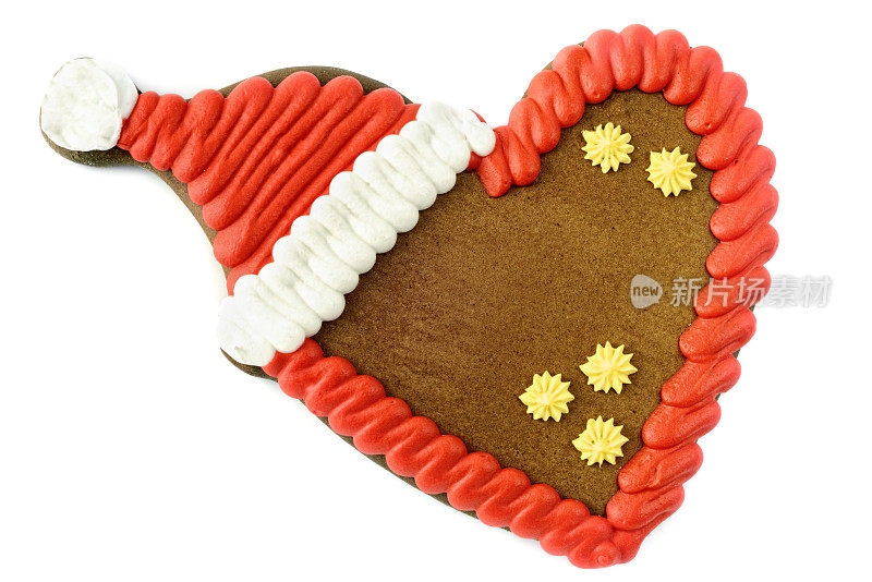 圣诞姜饼心饼干与红色的圣诞老人的帽子。