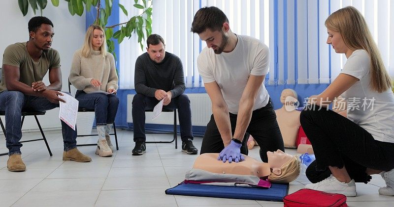 在急救培训课程中，讲师在人体模型上演示心肺复苏术。